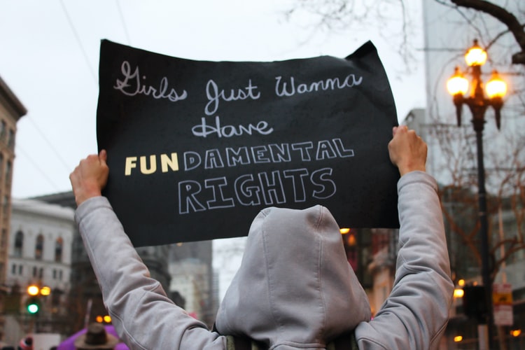 Person holding up sign saying girls just want to have fundamental rights
